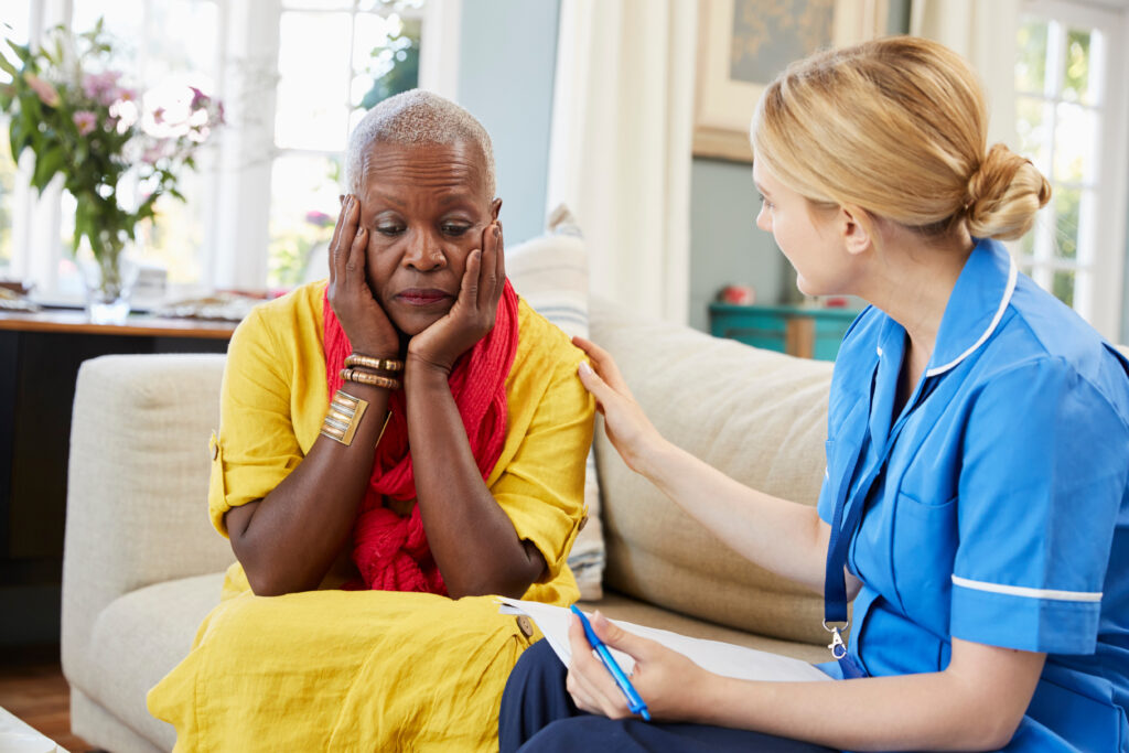 Adult day professional comforts woman with dementia